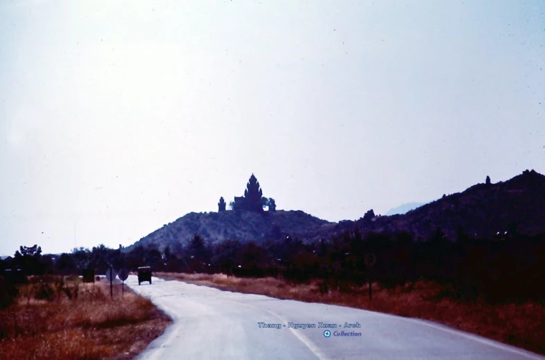 a view of a castle from the street on the side of the road