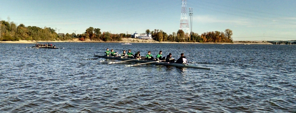 five boats full of people on a large body of water