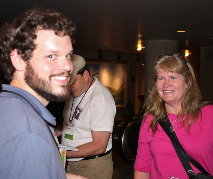 man and woman at a party wearing pink shirts