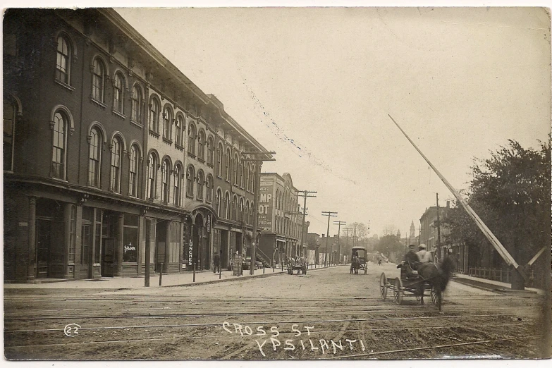 an old time looking town street with buildings on either side