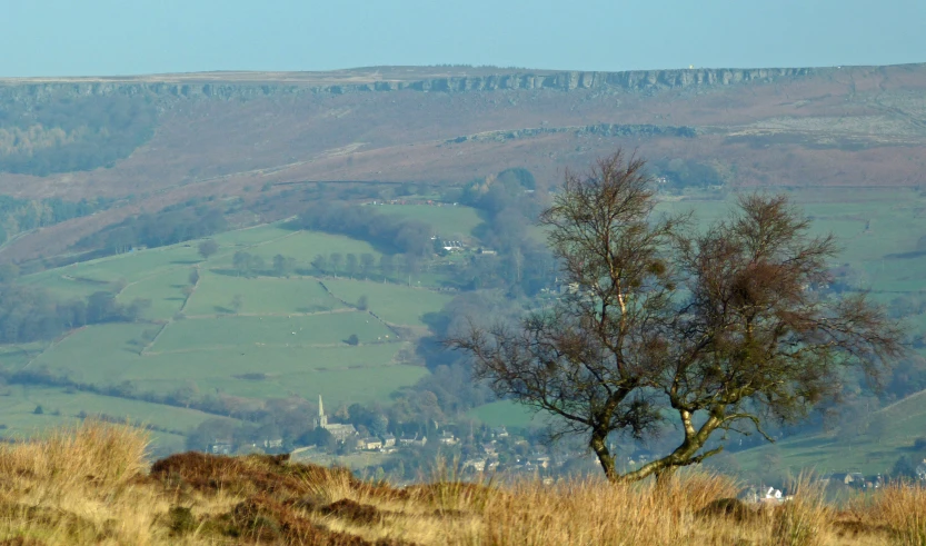 a large hill covered with lots of green and brown grass