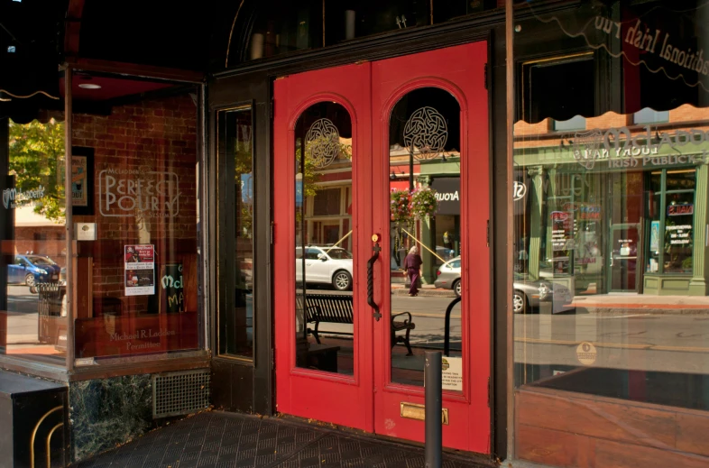 a red double door that is standing in front of a building