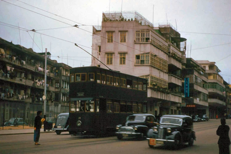 two cars and a bus in a city street