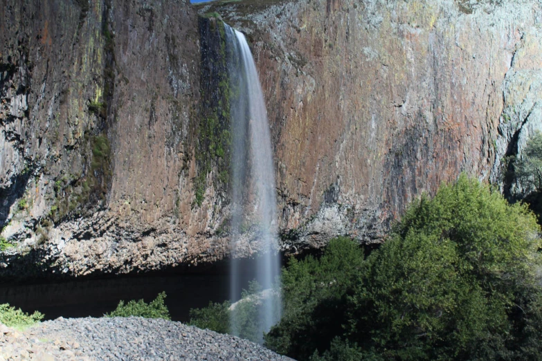 a very large waterfall in the side of a cliff