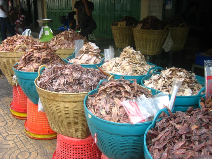 baskets full of seafood at a stall in the market