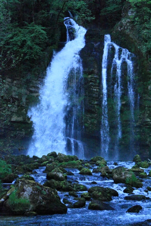 an image of waterfall that appears to be in the woods