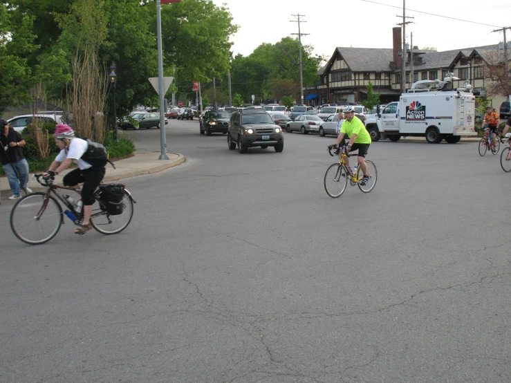 several bikers are riding in the middle of the road