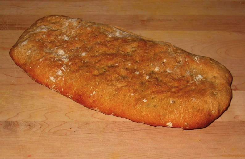 a slice of bread on a wooden  board