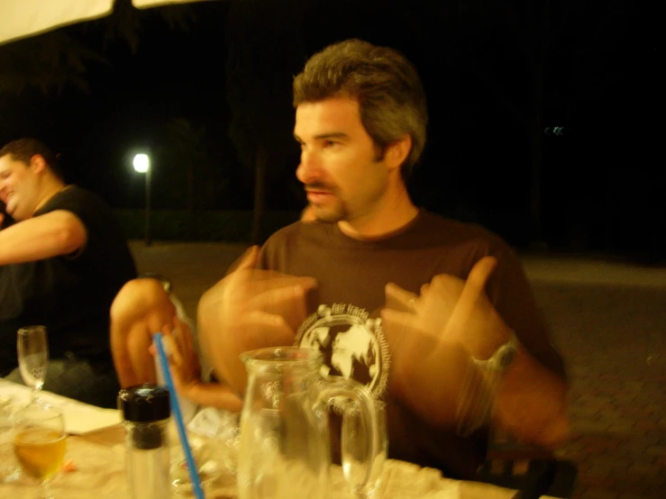 a group of men sitting around a table together