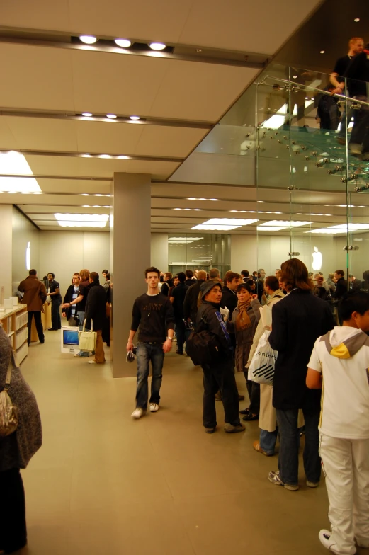 many people standing inside of an open building