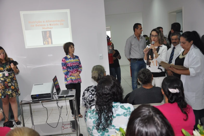 a group of people standing around a room