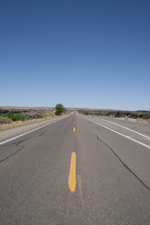 the street has a straight line to show how many roads have yellow stripes