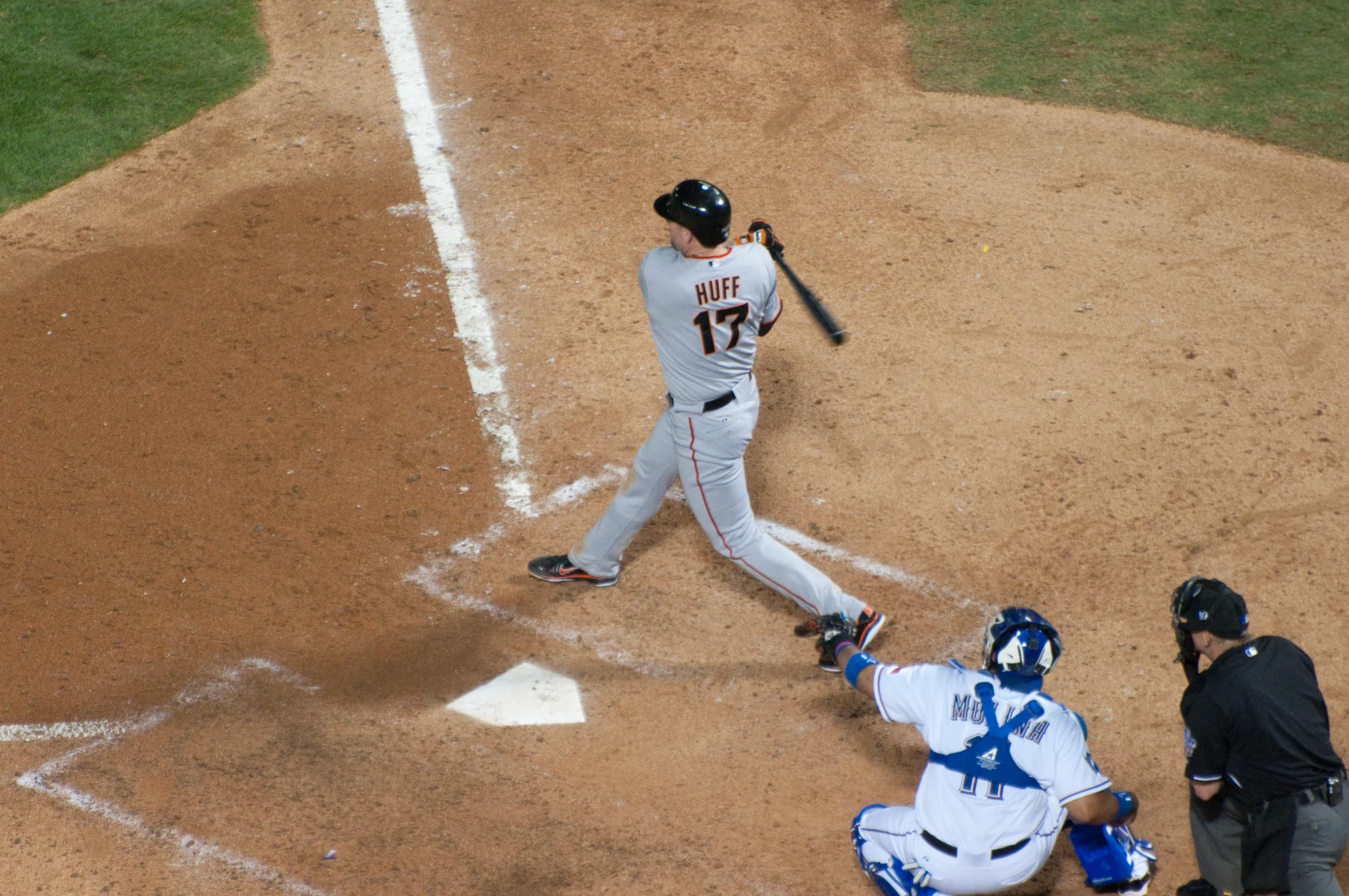 a professional baseball player swinging at a pitch