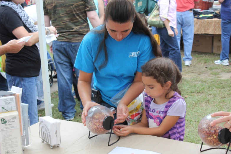 two girls are making items for a party