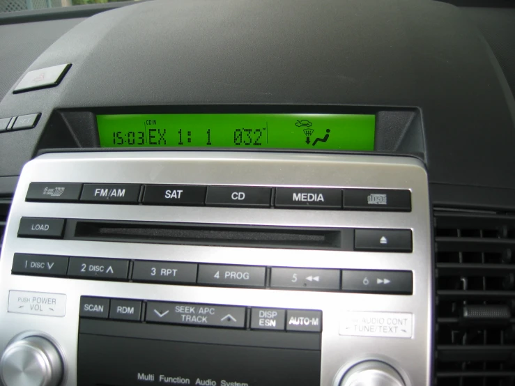 an electronic clock mounted in the center of a car