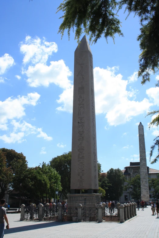 the obelisk stands tall against the blue sky