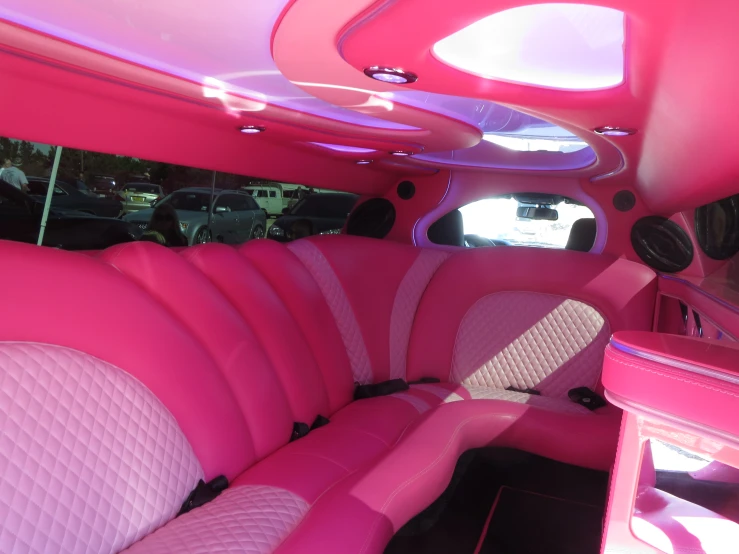 the inside view of a pink van filled with furniture