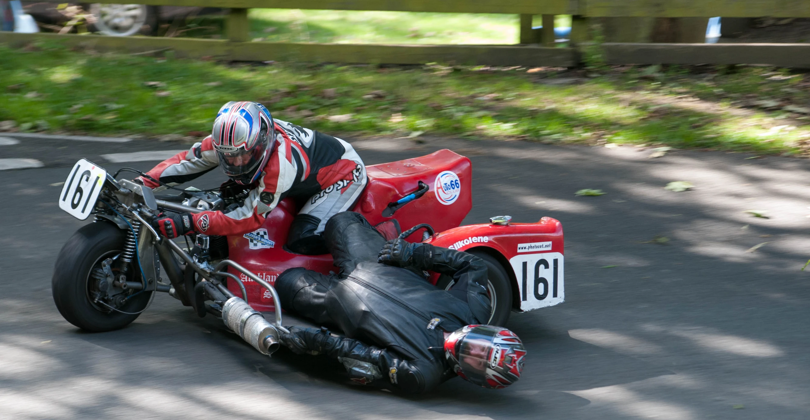 a man riding on the back of a red motorcycle