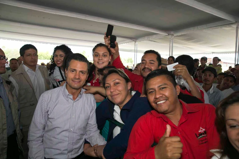 a group of people standing and giving thumbs up