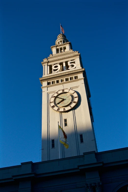 large tower made with white and gray marble and clock in center