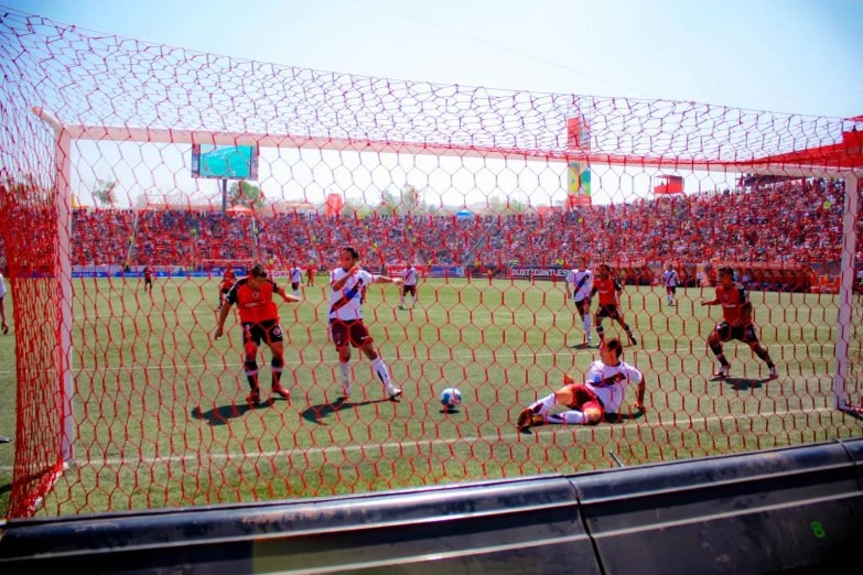 a group of men on a field playing soccer