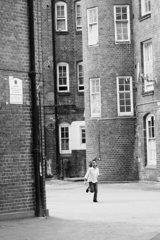 a young child standing next to some buildings