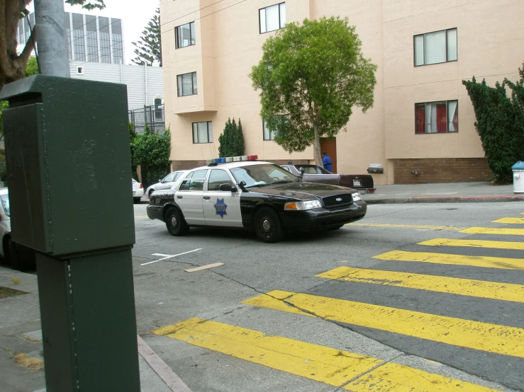 a police car parked next to an empty street