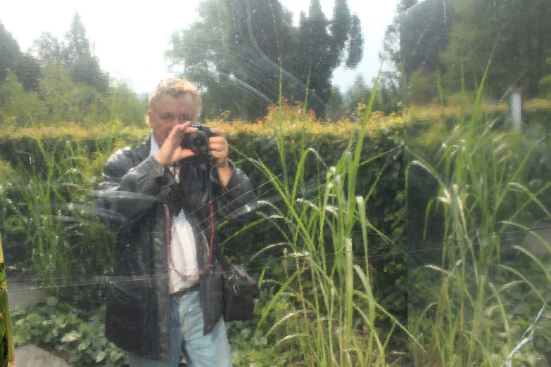 the man is taking pictures in the mirror