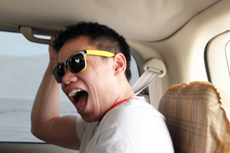 a man riding in the back of a car with his hand on his hip