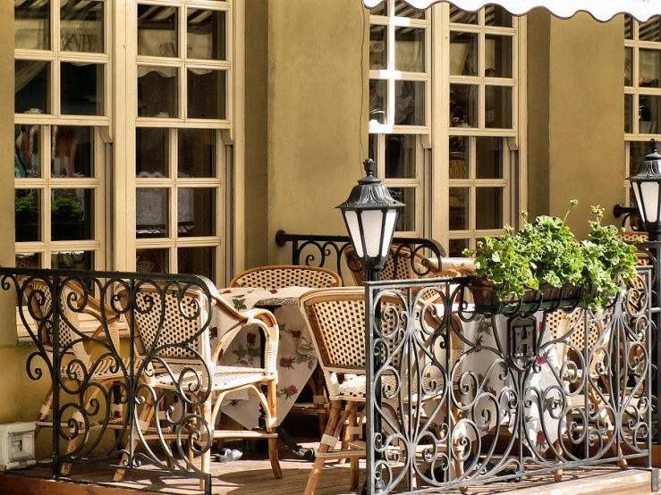 an outdoor patio table covered in chairs