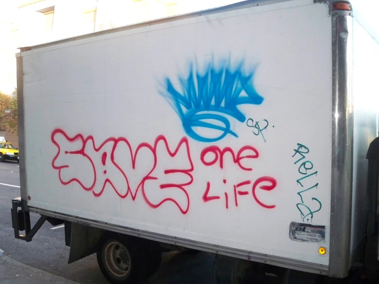 white and red truck with some graffiti on it