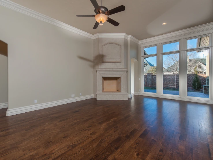 a living room with hard wood floors, and fan