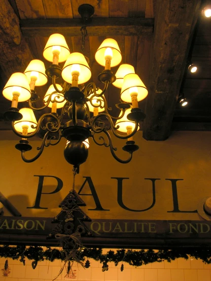a chandelier is displayed above a restaurant sign