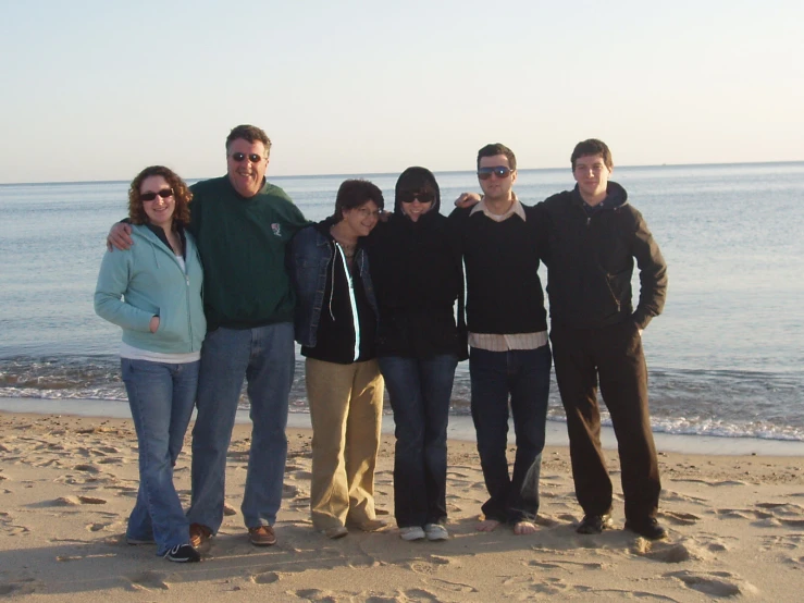 a family is posing together on the beach