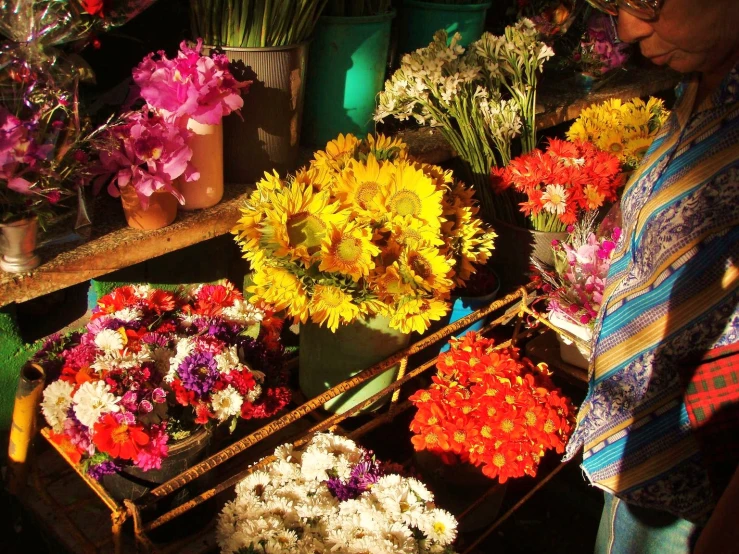 a woman is arranging flowers in a shop