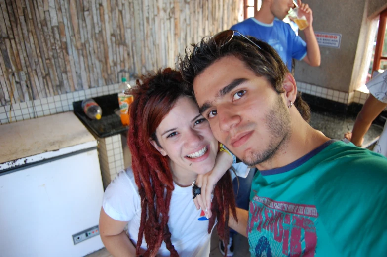 a young man and woman taking a selfie in a bathroom