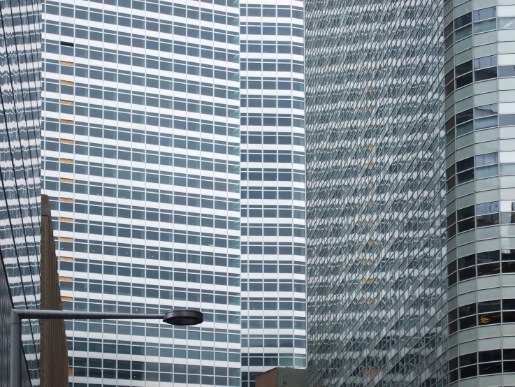 the side of two large buildings that are very tall