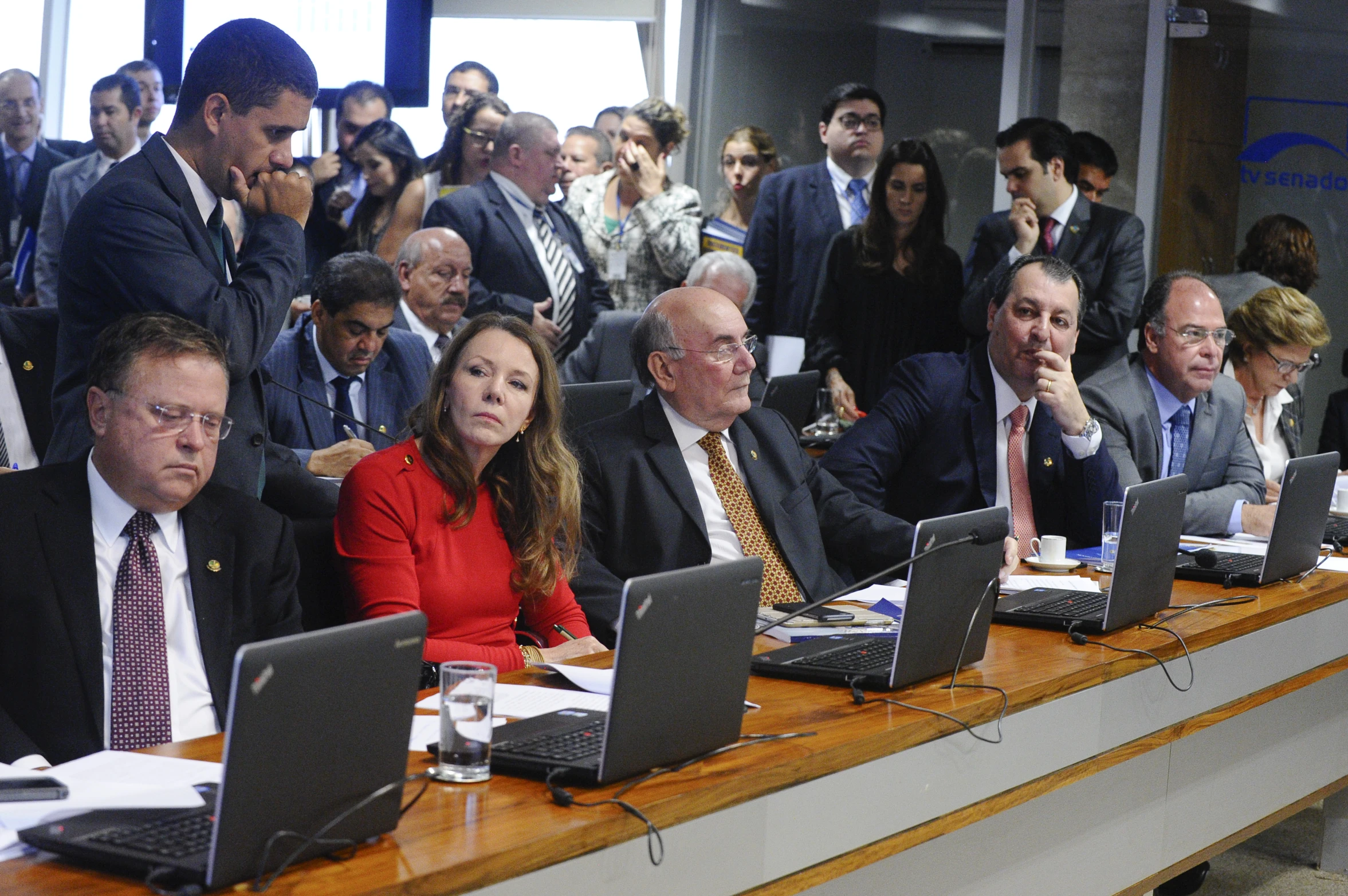 a group of people sitting at desks with laptop computers