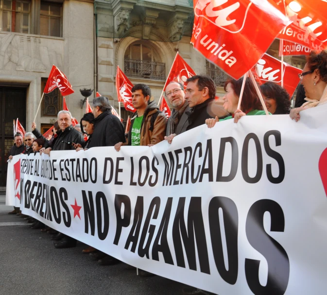 people standing together with protest signs and banners