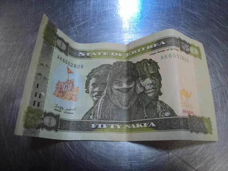 a twenty five dollar bill is folded like a book