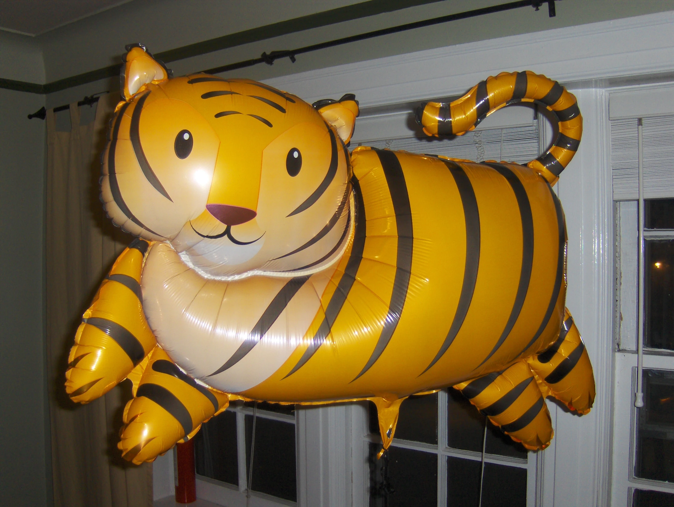 an inflatable tiger balloon hanging in the air