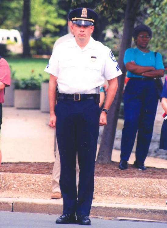 a police officer stands on the street with other officers