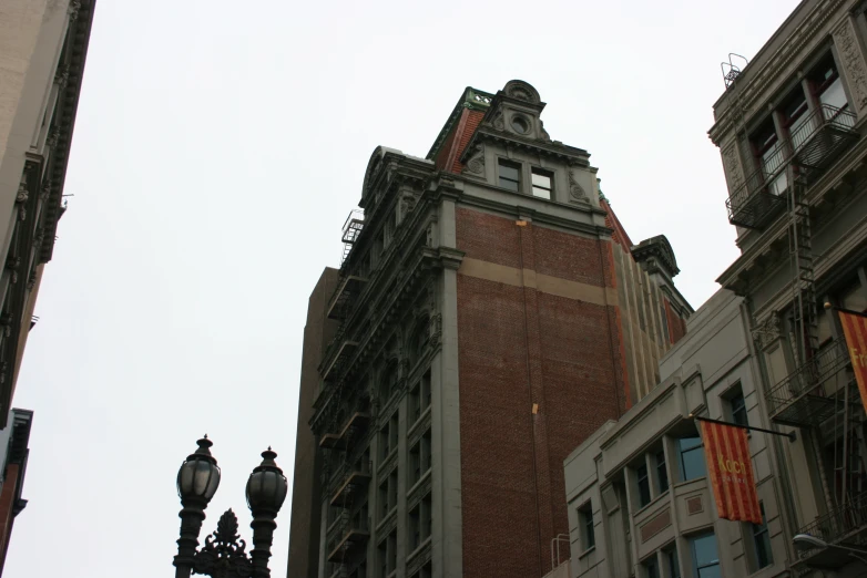 a tall brick building sits among other large buildings