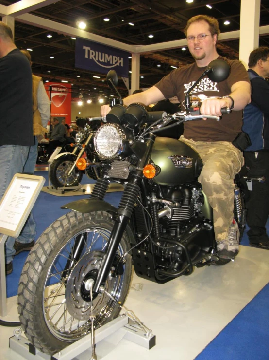 a man on a motorcycle parked at an event