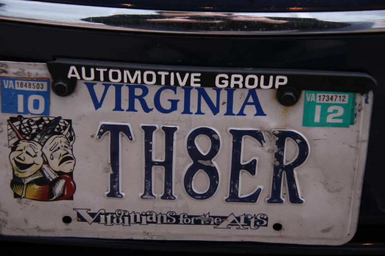 a closeup of a black and white license plate for an automobile