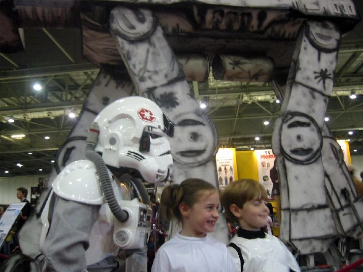 two girls standing next to each other near giant items