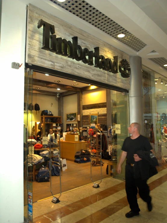 a man is walking through an upscale department store