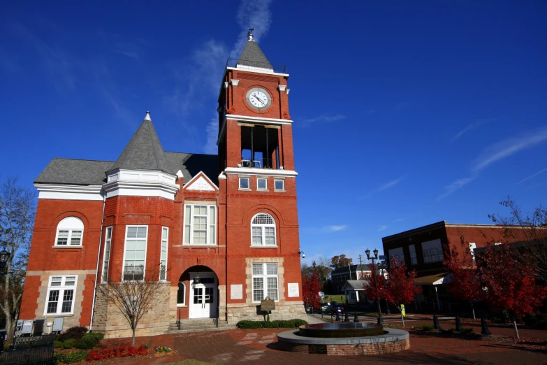 a large brick building with a clock on it's side