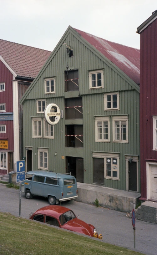 a car and bus parked outside a building