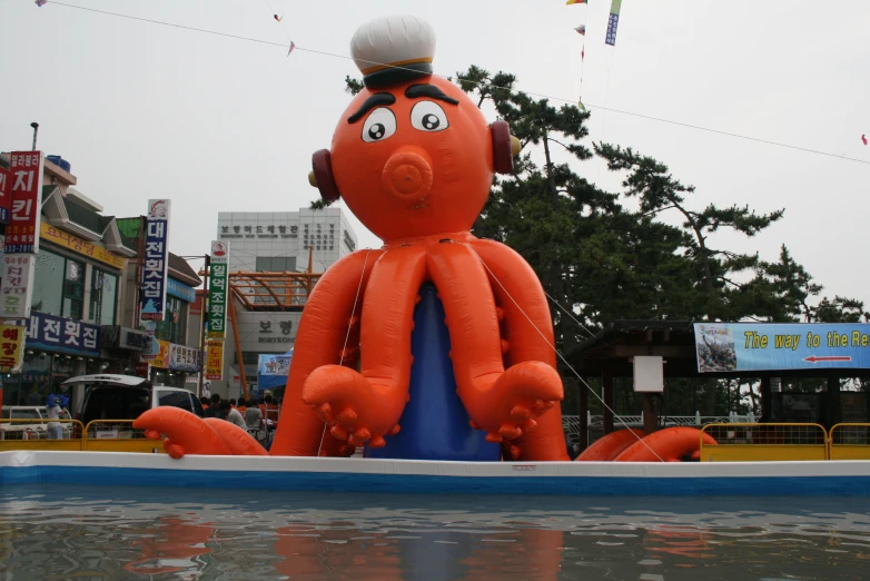 a strange balloon float sitting on top of a lake